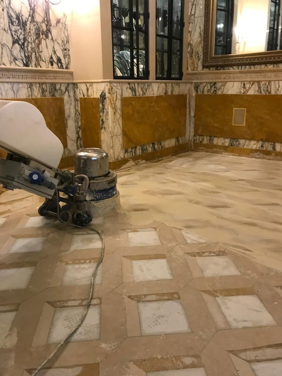 Rotary floor machine restoring a natural stone floor